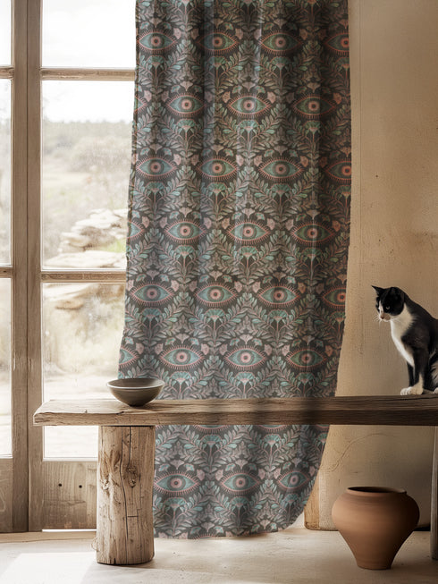 Sheer curtain panel featuring repeating sage green and blush pink evil eye motif surrounded by botanical elements on dark gray background. Linen-textured polyester fabric allows filtered light while providing elegant window covering with protective symbolism for Victorian or gothic interiors.